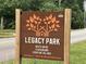 Legacy Park sign at entrance showing park hours and village playground at 834 S Columbia Dr, Decatur, GA 30030