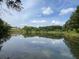 Calm community pond reflecting the forest and sky, creating a serene and picturesque setting at 834 S Columbia Dr, Decatur, GA 30030