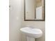Bathroom featuring a decorative framed mirror, pedestal sink, and chrome fixtures at 111 Centennial Ridge Dr, Acworth, GA 30102