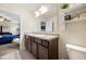 Bright bathroom featuring a double sink vanity, a view of the bedroom, and neutral flooring at 111 Centennial Ridge Dr, Acworth, GA 30102