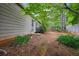 View of the backyard with partial privacy fence and natural landscaping at 141 Springbrooke Trl, Dallas, GA 30157