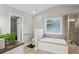 Bathroom featuring a soaking tub with tiled surround and glass enclosed shower at 141 Springbrooke Trl, Dallas, GA 30157