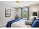 This bedroom features neutral walls, a ceiling fan, and blue bedding for a calm effect at 141 Springbrooke Trl, Dallas, GA 30157