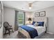 This bedroom features neutral walls, a ceiling fan, and blue bedding for a calm effect at 141 Springbrooke Trl, Dallas, GA 30157