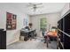 This office bedroom features two desks and chairs, a shelf, and a patterned wall hanging at 141 Springbrooke Trl, Dallas, GA 30157