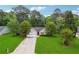 Charming one story home with a two car garage, green lawn, and a bright red front door at 141 Springbrooke Trl, Dallas, GA 30157