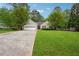 The home has a well manicured lawn, mature trees, and a long driveway that can fit multiple vehicles at 141 Springbrooke Trl, Dallas, GA 30157