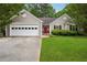 Charming single-story home features a well-maintained lawn, a two-car garage, and a bright red front door at 141 Springbrooke Trl, Dallas, GA 30157