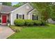 Landscaped front yard with mature shrubbery and a pop of color from the home's bright red front door at 141 Springbrooke Trl, Dallas, GA 30157