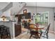 This eat-in kitchen includes stainless appliances, dark cabinetry, a tile backsplash, and barstool seating at 141 Springbrooke Trl, Dallas, GA 30157