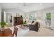 Cozy living room with vaulted ceilings, plush carpeting, and a view to an adjacent dining room at 141 Springbrooke Trl, Dallas, GA 30157