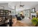 An open-concept living room features a fireplace, French doors, high ceilings, and a view into the kitchen at 141 Springbrooke Trl, Dallas, GA 30157