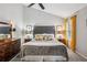 This cozy main bedroom offers neutral walls, a ceiling fan and a dresser with decorative lamps at 141 Springbrooke Trl, Dallas, GA 30157
