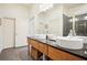 Modern bathroom featuring double sinks, granite countertops, and a glass-enclosed shower at 1430 Dresden Ne Dr # 230, Brookhaven, GA 30319