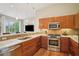 Modern kitchen featuring stainless steel appliances, granite countertops, and wooden cabinets at 1430 Dresden Ne Dr # 230, Brookhaven, GA 30319