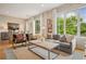 Bright living room featuring a comfortable couch, hardwood floors, and large windows offering ample natural light at 1430 Dresden Ne Dr # 230, Brookhaven, GA 30319