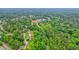 A high aerial view showcases a community surrounded by dense trees and lush greenery at 2801 Holly Oaks Dr, Marietta, GA 30062