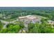 Arial view of a well-maintained brick home in a wooded neighborhood near a school at 2801 Holly Oaks Dr, Marietta, GA 30062