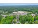 Aerial view of a brick home nestled among lush green trees in a quiet neighborhood at 2801 Holly Oaks Dr, Marietta, GA 30062