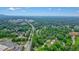 Extensive aerial view features a mix of residential and commercial areas surrounded by a canopy of trees at 2801 Holly Oaks Dr, Marietta, GA 30062