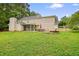 Large backyard with a screened-in porch, patio area, and lush green lawn at 2801 Holly Oaks Dr, Marietta, GA 30062