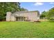 Expansive backyard featuring a screened porch, patio, and cozy fire pit area at 2801 Holly Oaks Dr, Marietta, GA 30062