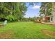 Large backyard with a patio, outdoor seating, and lush green grass, perfect for relaxation at 2801 Holly Oaks Dr, Marietta, GA 30062