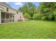 Expansive backyard featuring a lush lawn, mature trees, and outdoor seating areas at 2801 Holly Oaks Dr, Marietta, GA 30062