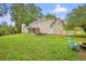 Large backyard featuring a screened porch, dining area, and fire pit perfect for gatherings at 2801 Holly Oaks Dr, Marietta, GA 30062