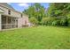 Expansive backyard featuring a screened porch, patio with dining, and cozy fire pit area at 2801 Holly Oaks Dr, Marietta, GA 30062