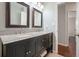 Bathroom featuring granite countertop and double sinks with dark wood cabinets at 2801 Holly Oaks Dr, Marietta, GA 30062