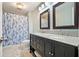 Bathroom featuring a dual sink vanity with granite countertops and a nautical shower curtain at 2801 Holly Oaks Dr, Marietta, GA 30062