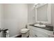 Elegant half-bathroom featuring a marble countertop and white vanity at 2801 Holly Oaks Dr, Marietta, GA 30062