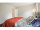 Bright bedroom with warm bedding, neutral walls, hardwood floors and natural light at 2801 Holly Oaks Dr, Marietta, GA 30062