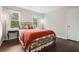 Bright bedroom features hardwood floors, two windows, and a decorative wrought iron bed frame at 2801 Holly Oaks Dr, Marietta, GA 30062