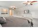 A bright primary bedroom featuring stylish decor, soft gray carpet, and a large entertainment center at 2801 Holly Oaks Dr, Marietta, GA 30062