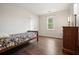 This bedroom features hardwood floors, neutral walls, and a window with natural light at 2801 Holly Oaks Dr, Marietta, GA 30062