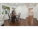 Inviting breakfast nook features rich hardwood floors, a round table and sun-filled windows at 2801 Holly Oaks Dr, Marietta, GA 30062