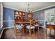 Formal dining room featuring hardwood floors, elegant chandelier, and a charming china cabinet at 2801 Holly Oaks Dr, Marietta, GA 30062