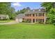Traditional brick home featuring a well-manicured lawn and three-car garage at 2801 Holly Oaks Dr, Marietta, GA 30062