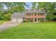 Charming brick home with a manicured lawn and a three-car garage at 2801 Holly Oaks Dr, Marietta, GA 30062