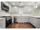 Updated kitchen with stainless steel appliances, white cabinets, and modern fixtures at 2801 Holly Oaks Dr, Marietta, GA 30062