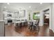 Open kitchen and dining area featuring hardwood floors, stainless steel appliances, and neutral gray cabinets at 2801 Holly Oaks Dr, Marietta, GA 30062