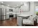 Modern kitchen with stainless steel appliances, hardwood floors, and breakfast bar seating at 2801 Holly Oaks Dr, Marietta, GA 30062