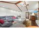 Modern living room featuring stone fireplace, beamed ceilings, and sleek sectional at 2801 Holly Oaks Dr, Marietta, GA 30062