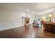 Comfortable living room includes a brick fireplace, dark hardwood floors, and natural light at 2801 Holly Oaks Dr, Marietta, GA 30062