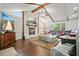Open living room with fireplace, vaulted ceilings, exposed beams, and unique coffee table at 2801 Holly Oaks Dr, Marietta, GA 30062