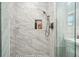 Modern bathroom shower featuring sleek marble tile and glass enclosure at 2801 Holly Oaks Dr, Marietta, GA 30062