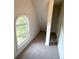 Finished attic with unique window and neutral carpet at 310 Bloomfield Ct, Roswell, GA 30075