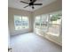 Bedroom with carpet and multiple large windows offering a view of the backyard at 310 Bloomfield Ct, Roswell, GA 30075